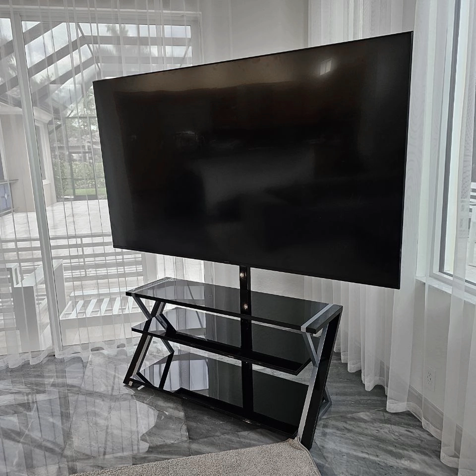 Outdoor TV stand with wall-mounted TV installation