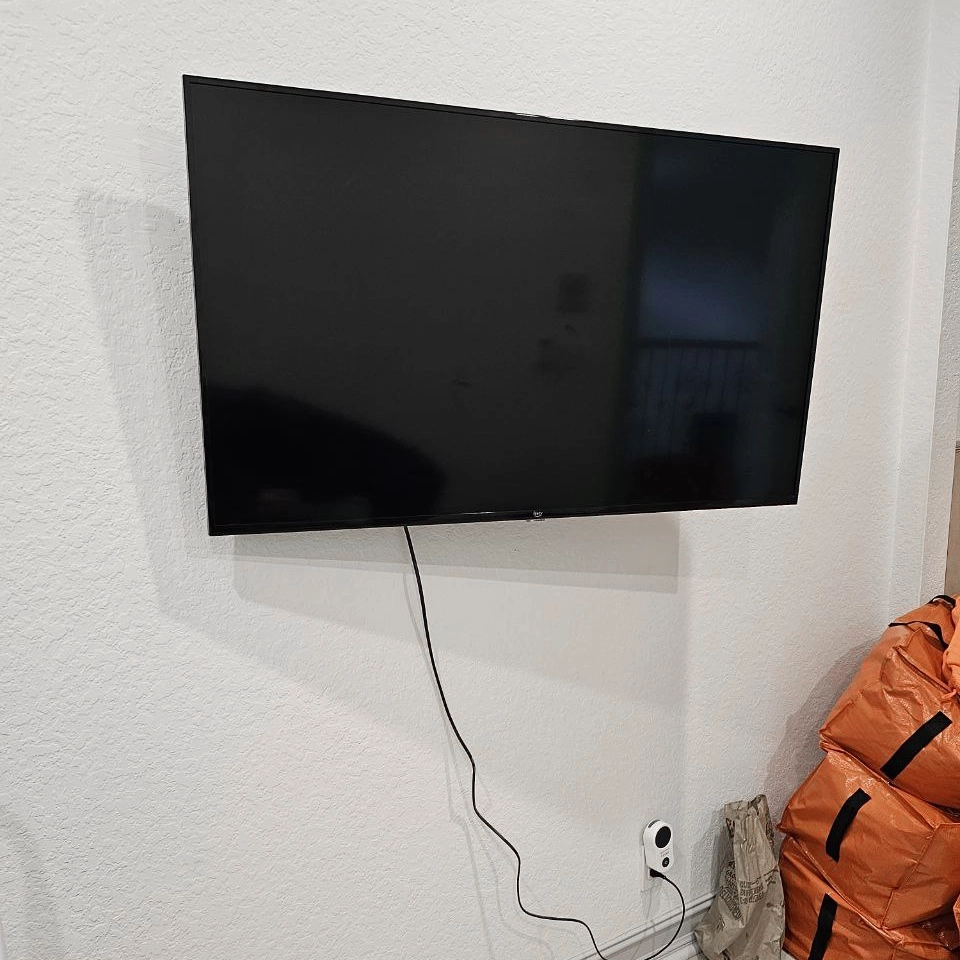 Soundbar installed below mounted TV for better sound